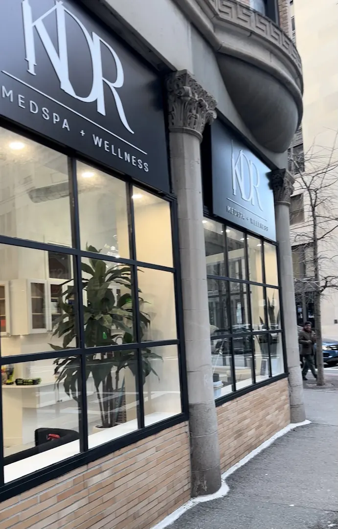 Black-framed storefront windows beneath two black KDR Medspa + Wellness signs