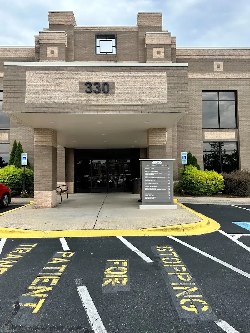 Brick medical office building entrance with 330 address sign and Billingsley Road directory