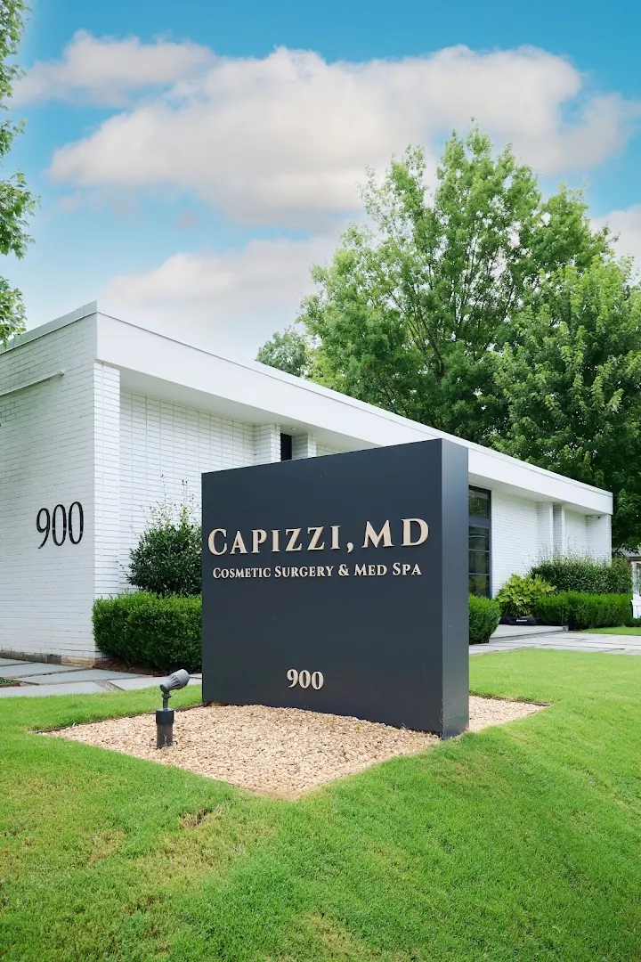 Capizzi MD monument sign marked 900 in front of a single-story white brick building