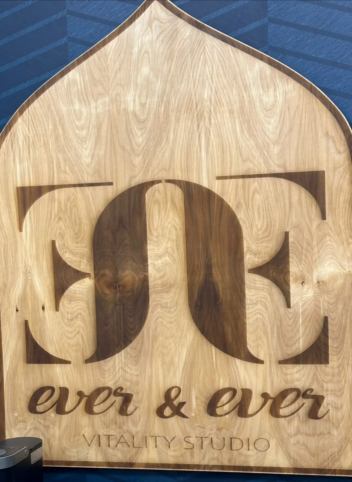 Carved wooden arched sign reading ever & ever Vitality Studio