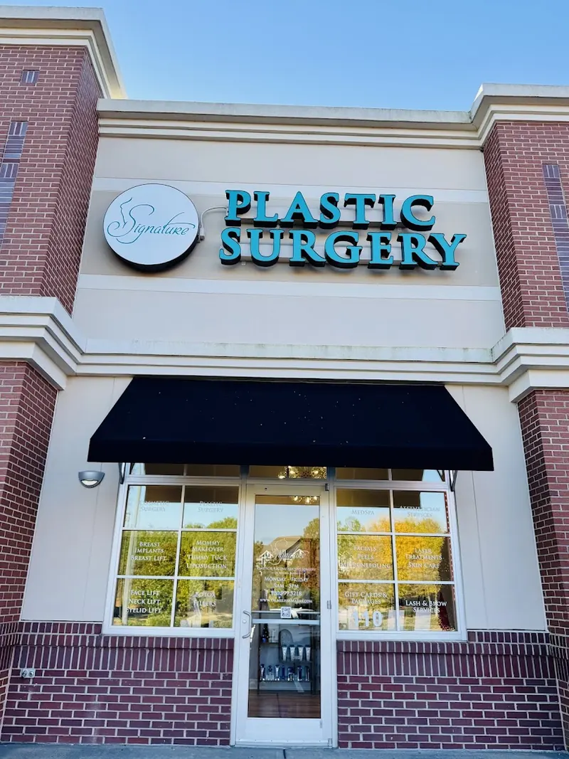 Brick storefront with a Signature logo and teal Plastic Surgery sign above a black awning