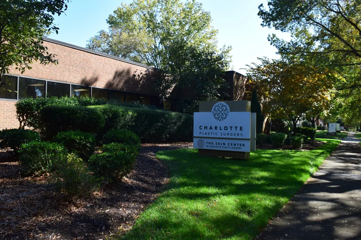 Charlotte Plastic Surgery and The Skin Center monument sign in front of a brick office building