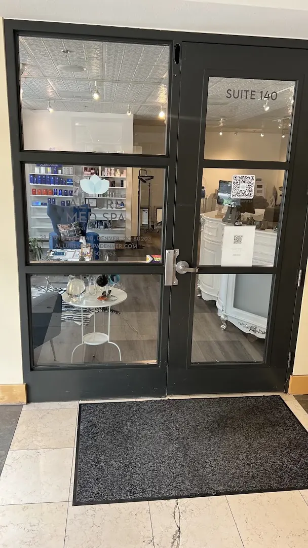 Black glass doors marked Suite 140 with an Allure Med Spa decal