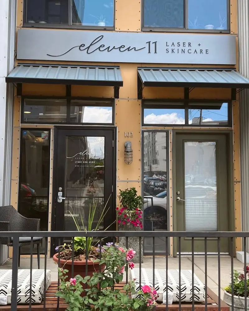 Storefront under an eleven 11 Laser + Skincare sign with green awnings and suite number 102