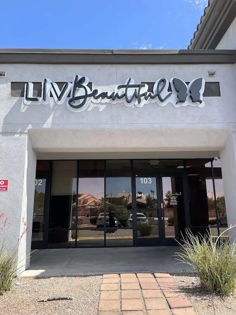 LIV Beautiful sign with butterfly logo above glass storefront doors numbered 103