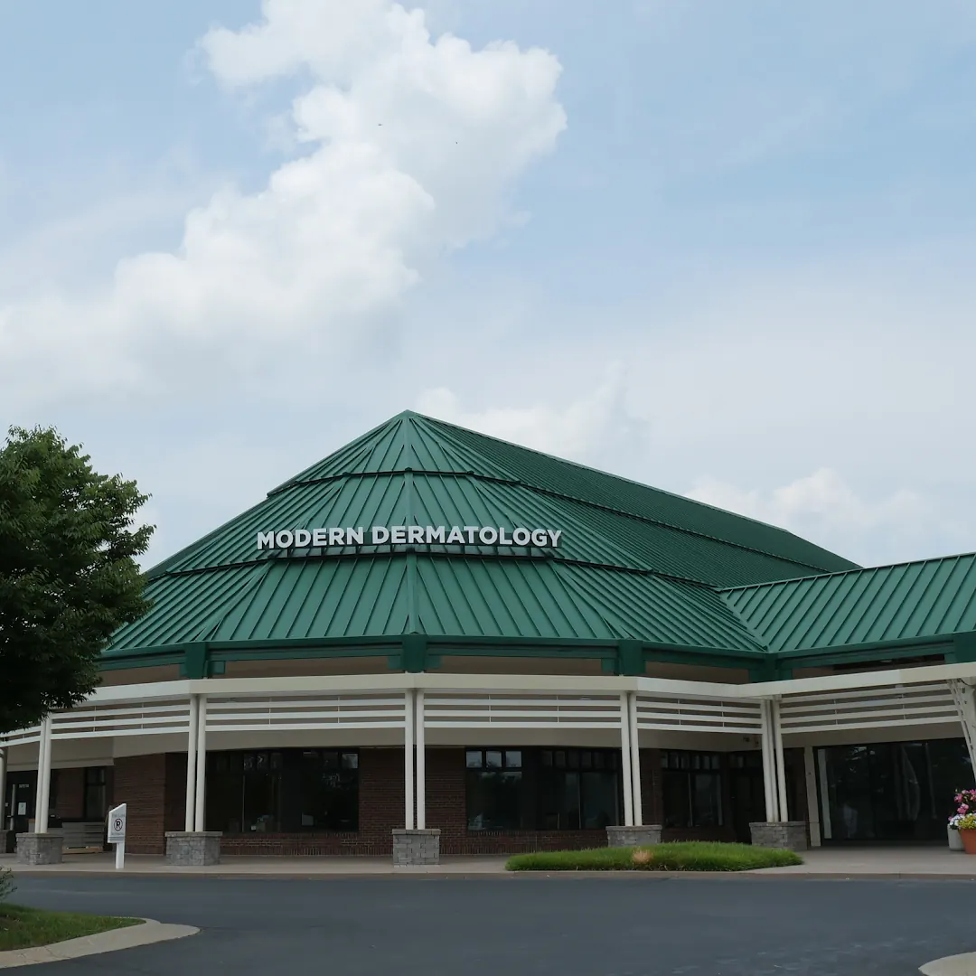 Modern Dermatology lettering on a green metal roof above a covered colonnade