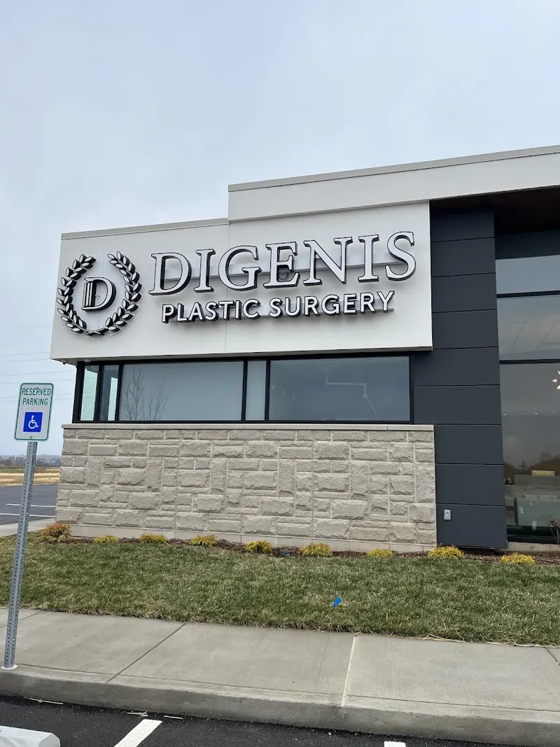 Digenis Plastic Surgery sign with laurel logo on a stone and panel building
