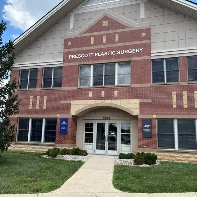 Red brick building with Prescott Plastic Surgery lettering above a glass entrance marked 2507