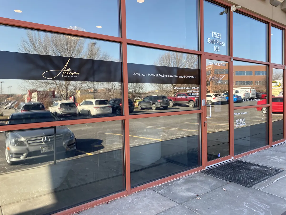 Glass storefront with an Artisan Aesthetics logo band and the number 17525 Gold Plaza 104