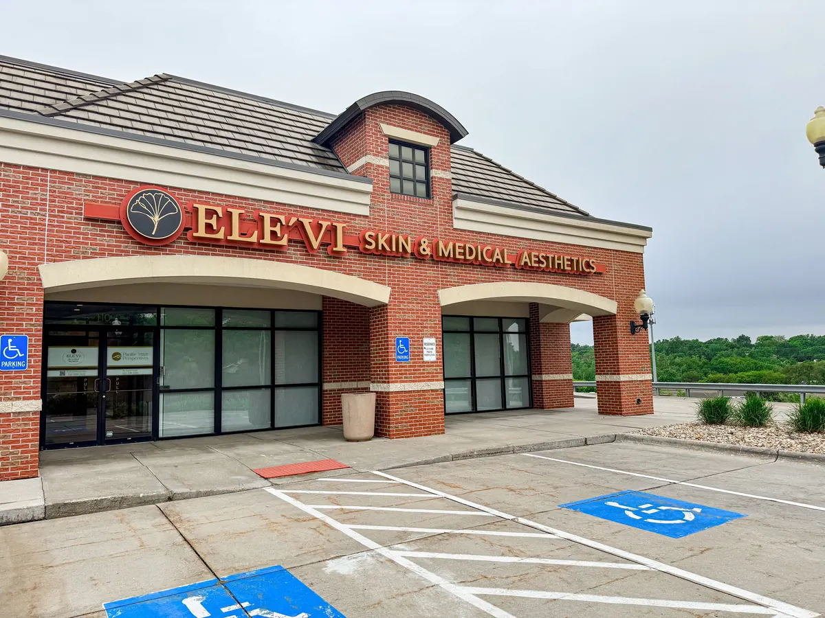 Brick building with a large ELE'VI Skin and Medical Aesthetics sign above glass doors