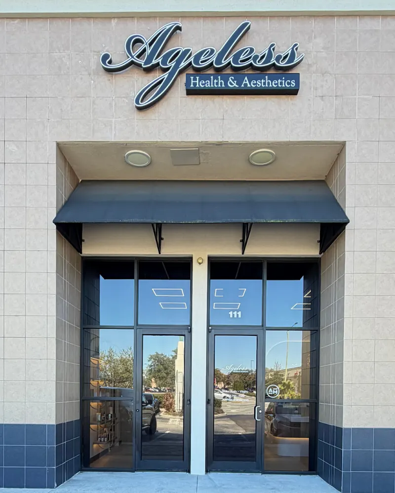 Ageless Health & Aesthetics sign above an awning-covered glass entrance marked suite 111