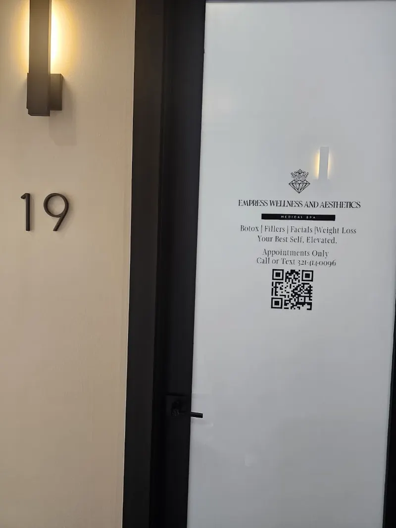 Frosted suite 19 door with an Empress Wellness and Aesthetics medical spa decal