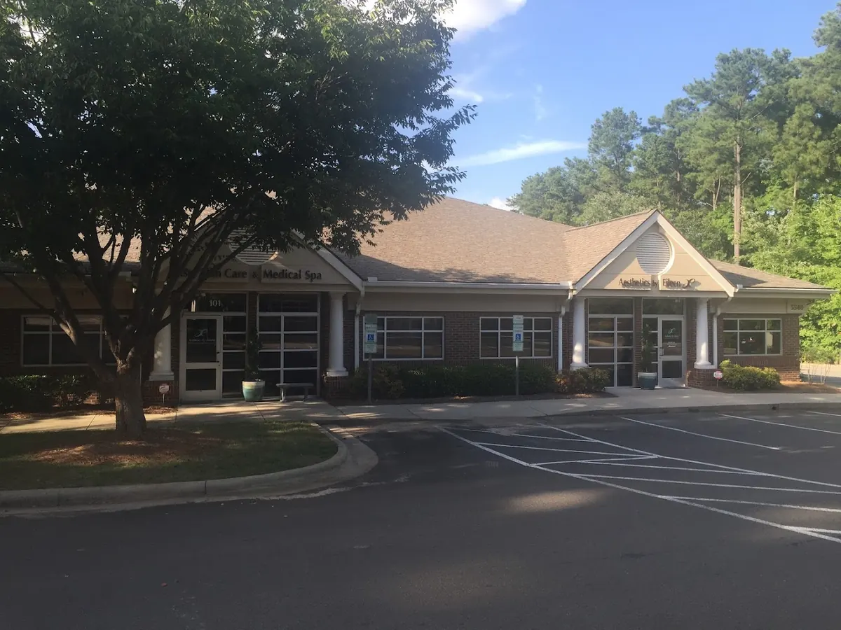 Brick single-story office building with an Aesthetics by Eileen gable sign and street number 5540