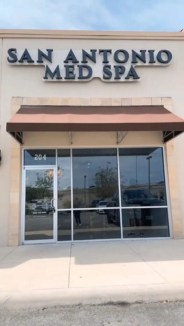 Storefront with San Antonio Med Spa sign, brown awning and suite 204 on the glass door