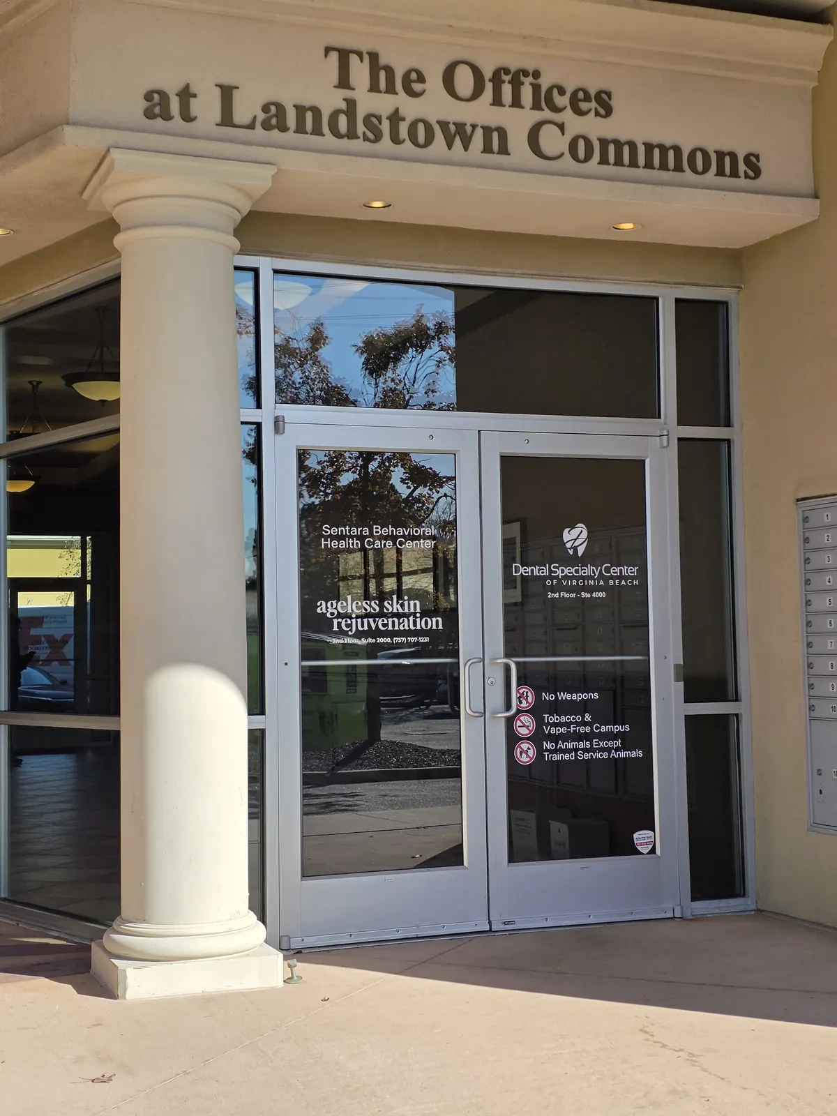 Glass double doors beneath The Offices at Landstown Commons lettering with practice names on the glass