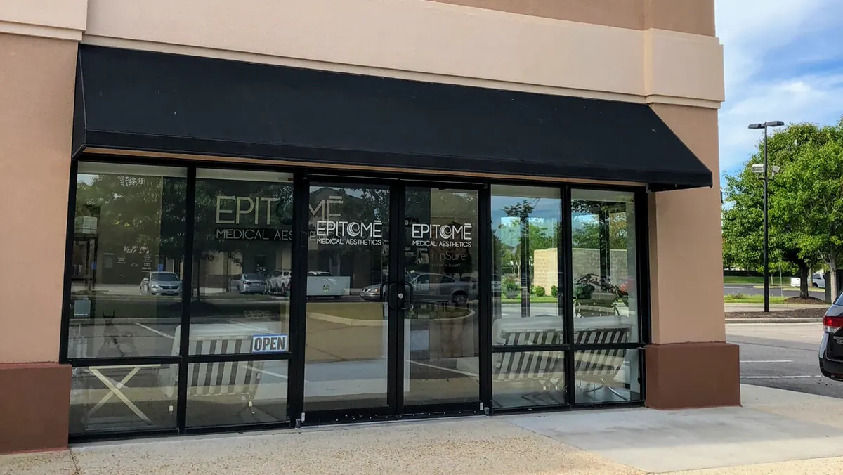 Beige storefront with a black awning and Epitome Medical Aesthetics lettering on the glass doors